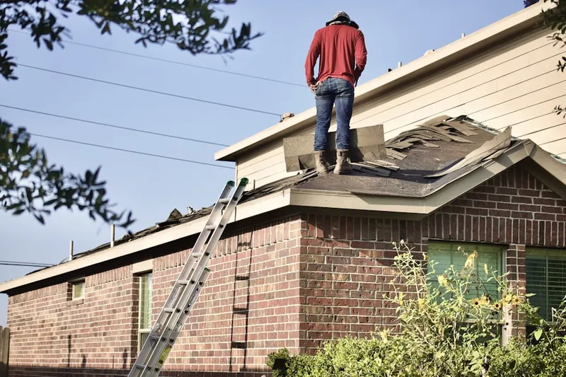 Professional roofer working on a residential roof in White Horse